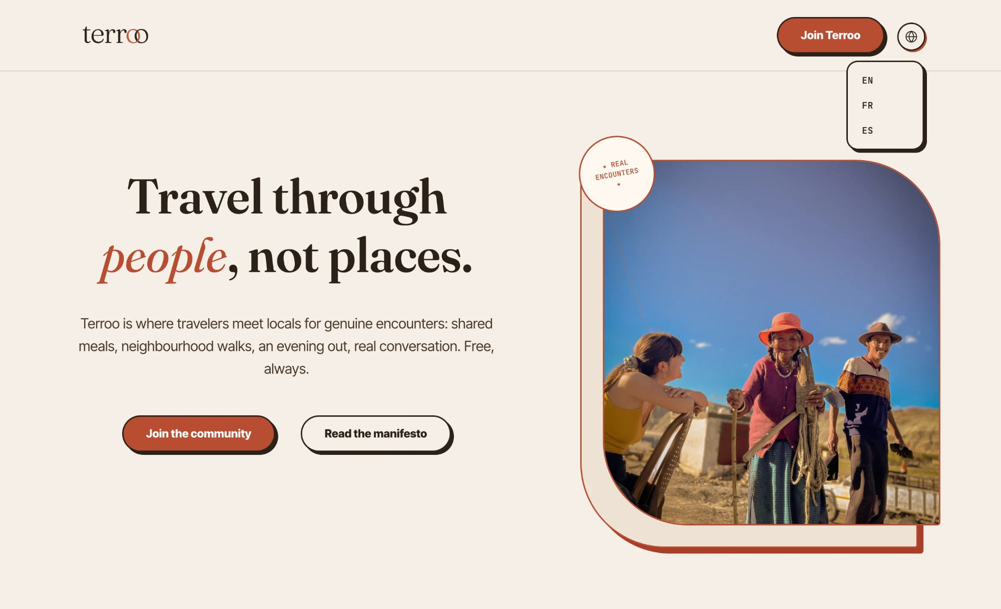 Terroo homepage hero: 'Travel through people, not places,' with a photo of a traveler meeting locals and a language switcher
